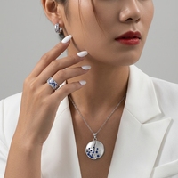 Ensemble de bijoux fins QX en argent 925 plaqué rhodium, avec pendentif disque asymétrique pavé de CZ bleus et blancs et bagues créoles larges ouvertes