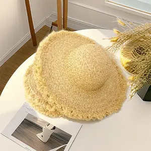 Sombrero de cubo trenzado ancho de paja de rafia para niños al por mayor con ala deshilachada para viajes al aire libre en la playa