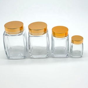 50ml 100mL 180ml 280ml 360ml 750ml Botella de miel de vidrio de forma cuadrada única Proveedor de tarros con tapa dorada utilizada para mermelada de pudín de miel - Product Image 4
