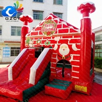 Château gonflable de Noël avec mur de briques et toboggan pour enfants, idéal pour les événements et fêtes de fin d'année à louer