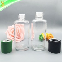 Bouteilles en verre de diffuseur rondes de 100ml à vendre Bouteille vide de diffuseur de roseau d'arôme avec le chapeau et le bouchon