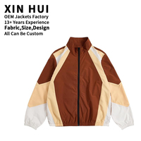 Veste de survêtement d'hiver pour homme XIN HUI personnalisable avec logo, coupe-vent respirant en nylon à panneaux colorés pour le sport et l'entraînement en extérieur (vente en gros)