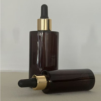 Flacon rond en verre ambré de 30 ml et 100 ml avec bouchon compte-gouttes doré et bulbe en TPE noir pour huile pour le visage et huile pour les cheveux