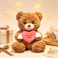 Ourson en peluche marron doux et moelleux, tenant un cœur avec des ailes d'ange, idéal pour un cadeau de Saint-Valentin - Vente en gros usine