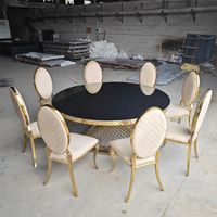 Table de bar ronde avec plateau en verre noir et base en grille en acier inoxydable doré