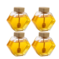 Bocaux en verre hexagonaux de haute qualité de 100 ml, 220 ml et 380 ml avec couvercles en bois pour le stockage du miel, des bonbons et du sucre