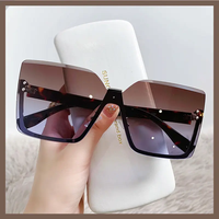 Lunettes de soleil 2026 pour femmes, style œil de chat, design tendance, nouvelles lunettes sans monture, vente en gros à bas prix pour femmes