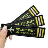 Vente en gros de logo personnalisé brodé Jet Tag Flight Textile Woven Fabric Longe Broderie Keytag Bagages Porte-clés