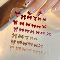 50 pièces/sac Breloques pour ongles en résine, motifs nœuds et rubans, mélange rouge, accessoires de décoration pour nail art, fournitures pour ongles