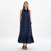 Gaun kemeja midi wanita custom grosir warna biru navy tanpa lengan, kerah runcing, kancing depan, saku samping, dan detail ruffle bertingkat.