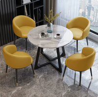 Ensemble table et chaises effet pierre moderne et compact pour réunions d'affaires et réception de clients, usage professionnel en bureau
