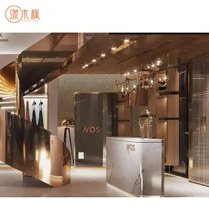 Trendsetting espositore per abbigliamento in oro eleva l'immagine del marchio espositore per abbigliamento opulento produttore di espositori per indumenti in metallo