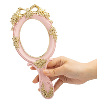 Miroir de maquillage à main en métal rose gaufré ovale européen de luxe Miroir à main cosmétique de voyage princesse vintage avec poignée