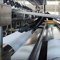 Machine automatique de revêtement et de stratification par pulvérisation thermofusible pour tissus, filtres, robes chirurgicales