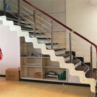 Escalier flottant sur mesure en acier au carbone avec marches en bois et garde-corps en verre pour la maison
