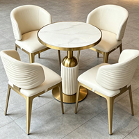 Ensemble table et chaises de salle à manger ronde pour hôtel et restaurant, plateau en pierre frittée, structure en acier inoxydable doré, table de café et salon de luxe avec 4 chaises