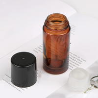 Flacon roll-on vide en verre ambré de 30 ml et 50 ml avec bille en quartz rose, emballé dans un carton sérigraphié