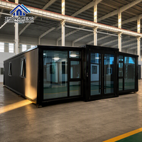 Tamamen Siyah Camlı Ön Cepheli Genişletilebilir Konteyner Ev, Tavandan Tabana Pencereler, Modern Balıksırtı Döşeme, Prefabrik Stüdyo, Depo Kullanımı