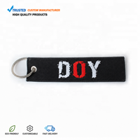 Fabricant de porte-clés en textile tissé personnalisé avec logo brodé à la machine, promotionnel, en sergé, vente en gros à prix abordable
