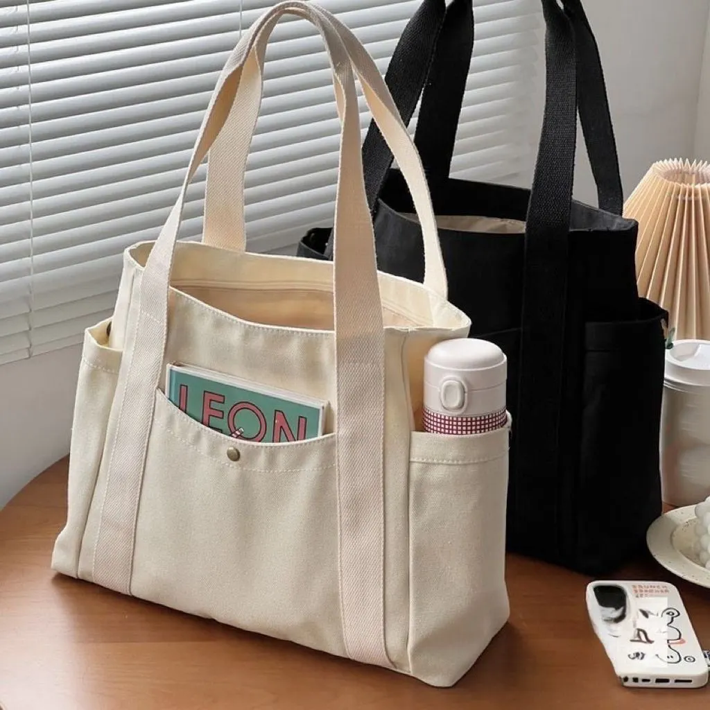 कस्टम प्रिंटिंग बड़ी क्षमता वाले शॉपिंग बैग महिला रेट्रो कई पॉकेट ब्लैक कैनवास टोट बैग लड़कियों के लिए यूनिवर्सिटी स्कूल बैग