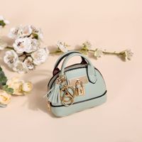 Porte-monnaie ovale mini en cuir de luxe écologique, mignon, avec porte-clés, cadeau de haute qualité pour voiture, vente chaude en gros