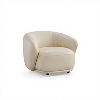 Fauteuil lounge rond moderne en cuir végétalien blanc crème avec accoudoir enveloppant, coussin moelleux et base basse, canapé d'appoint pour chambre et hôtel