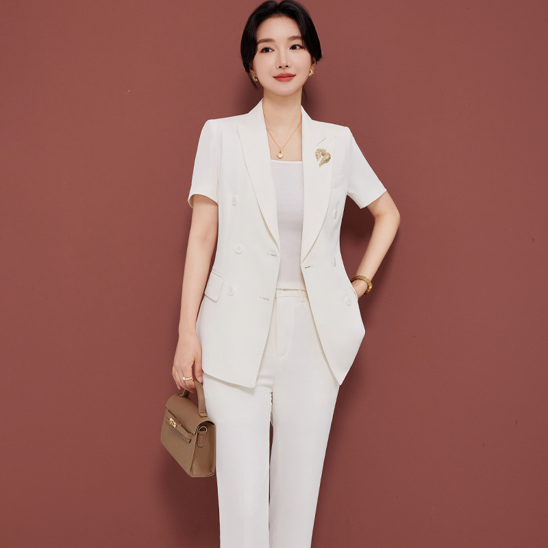 White suit trousers brooch