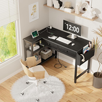 Bureau de jeu en forme de L réversible noir avec tiroirs, étagères de rangement, prise de courant, bureau d'angle pour ordinateur personnel pour la chambre des garçons