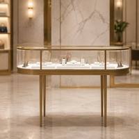 Table de présentation ovale en métal doré avec vitrine en verre trempé, comptoir de luxe pour bijouterie, pour l'affichage de colliers, bagues et boucles d'oreilles