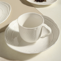 Ensemble de vaisselle en porcelaine blanche unie à motifs en relief minimaliste, comprenant un saladier, une assiette à soupe, une assiette à dîner de style français et une tasse