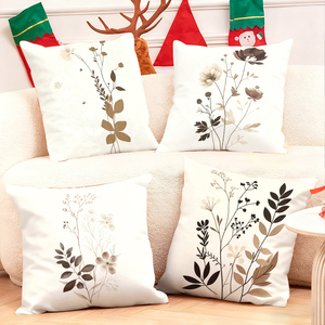 Elegantes cojines decorativos botánicos que adornan un sofá acogedor con calcetines navideños festivos y astas de reno en el fondo. - Product Image 1