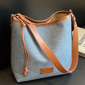 Casual <b>crossbody</b> <b>bag</b> with denim and leather stitching and drawstring embellishment - Product Image 4