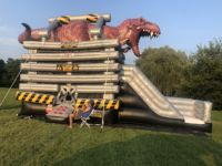 Château gonflable dinosaure 2026 avec toboggans aquatiques pour jardin, à vendre