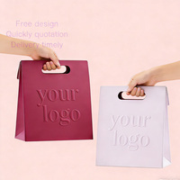 Sac shopping en papier rose personnalisé avec poignées en ruban pour l'emballage de produits cosmétiques, de cils et de produits de vente au détail