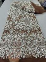 Tissu en dentelle de luxe brodé en gros, nouveau tissu en dentelle de haute qualité avec perles et strass pour robe de mariée et de soirée