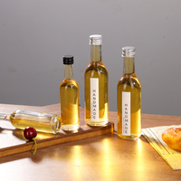 Bouteille en verre mini haute transparence de 50 ml et 100 ml avec étiquette personnalisée et bouchon en aluminium, conçue pour la bière, le brandy, les boissons énergisantes et le vin