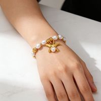Bracelet élastique en perles de coquillages plaqué or en acier inoxydable style plage d'été DAIHE