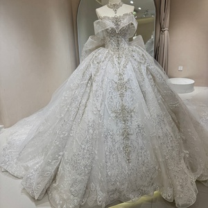 Vestido de Novia DW0195 Vintage Moderno con Hombros Descubiertos, Lentejuelas Color Marfil, Cola de Capilla, Encaje Largo y Flores de Cristal - Product Image 1