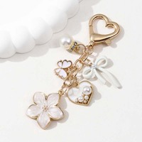 Porte-clés en métal pour femme, motif fleurs colorées et nœuds, avec perles et papillons, tendance et personnalisé, vente en gros
