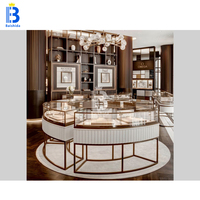 Vitrine de présentation de bijoux circulaire de luxe en or rose sur mesure avec éclairage LED pour boutique de bijoux, kiosque