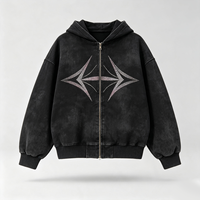 Veste à capuche zippée noire délavée effet vieilli avec détails géométriques étoiles en strass, épaules tombantes, coupe ample, style streetwear décontracté