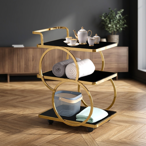 Chariot de bar moderne à trois niveaux avec roulettes, plateau en verre noir, structure en métal doré, étagère de rangement pour le service de boissons dans le salon - Product Image 1