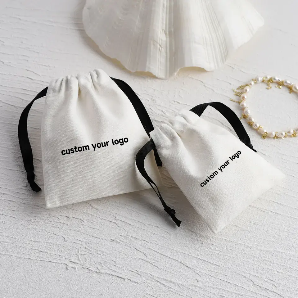 100 pièces toile coton sac à poussière Logo personnalisé bijoux emballage pochette à cordon avec ruban sac poussiéreux sac cadeau