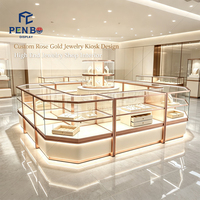Kiosque de présentation de bijoux de luxe sur mesure en or rose, vitrine à bijoux en verre éclairée par LED, comptoir d'îlot pour bijouterie de centre commercial
