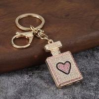 Porte-clés mousqueton en alliage léger et étanche, avec pendentif décoratif en forme de flacon de parfum orné de strass, pour femme, vente en gros, cadeau