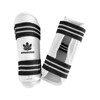 Protège-tibias de Taekwondo en mousse PU avec sangle élastique réglable pour l'entraînement et le sparring, personnalisables avec logo pour clubs et dojos, commande en gros