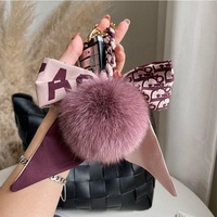 Magnifique porte-clés au design mignon avec motif de pompon et de nœud, porte-clés en cuir, porte-clés de luxe, porte-clés de créateur
