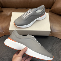 Sepatu Sneakers Pria Premium Kulit Asli Putih Sol Tebal Mewah Aksen Oranye untuk Jalan Santai Sehari-hari