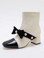 Bottines élégantes noires et blanches à empiècements, avec nœud en velours et détail perle, fermeture éclair latérale, bottes courtes tendance pour femme, idéales pour les soirées