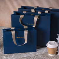 Sac cadeau de luxe en papier couché écologique et recyclable avec option de logo personnalisé estampé à chaud or et poignée en ruban longue pour exposition